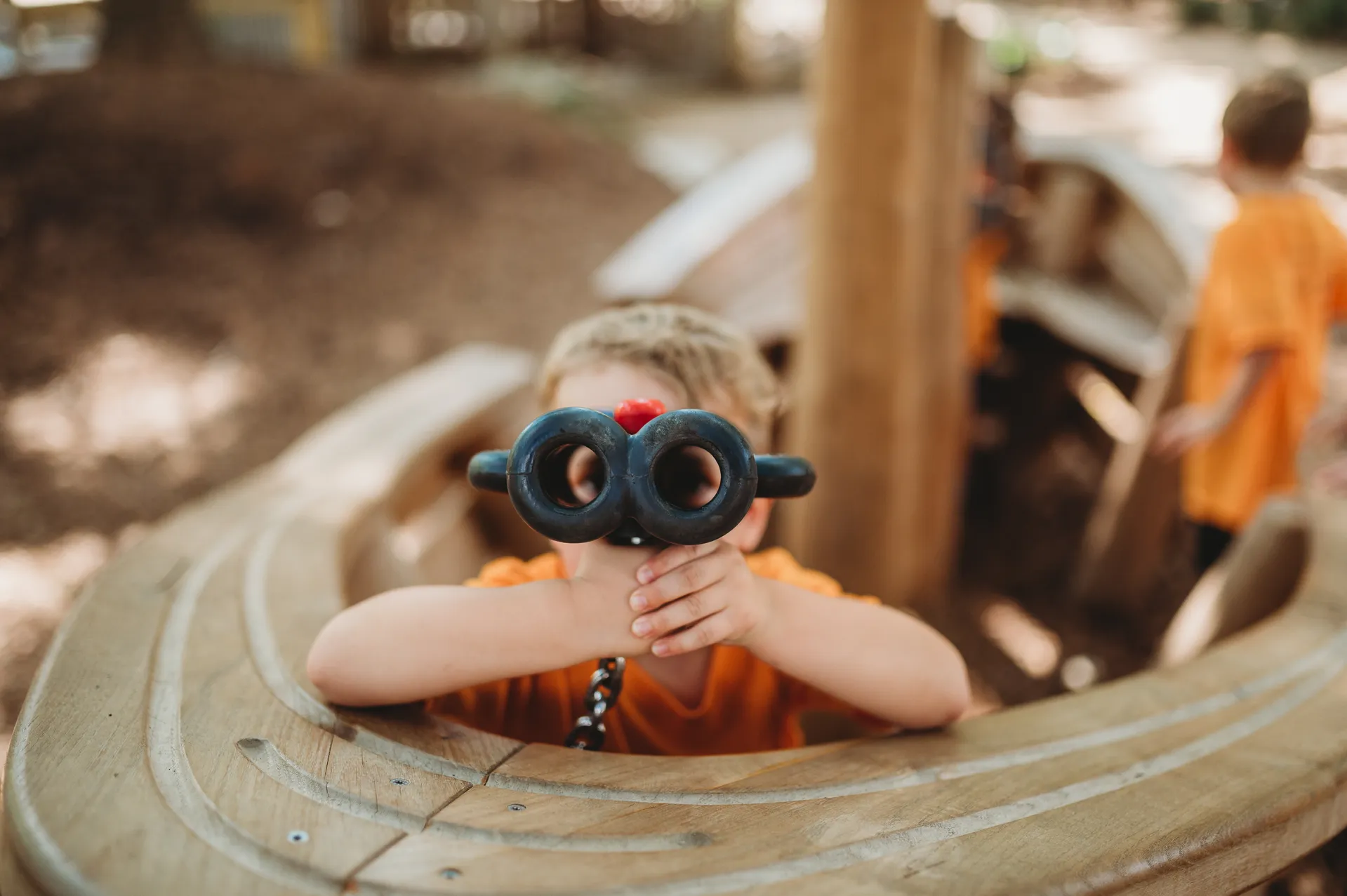 a child looking into binoculars